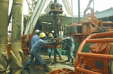 NIGERIA  Rivers State Workers using drill on oil rig.