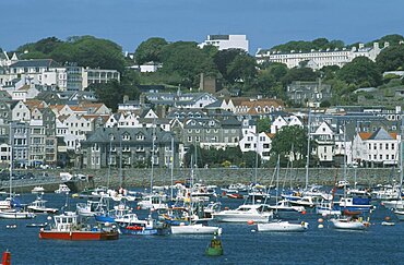 UNITED KINGDOM Channel Islands Guernsey St Peter Port. View from across sea towards marina and quayside buildings.