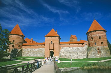 LITHUANIA  Trakai Visitors on bridge to entrance of Trakai Castle.