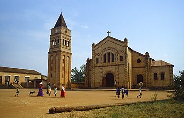 RWANDA  Religion Missionary church and school with women and children walking across courtyard in foreground.