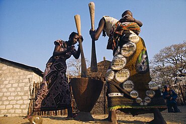 SENEGAL  Agriculture Women pounding maize  one carrying baby on her back.