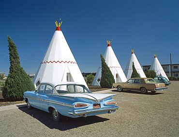 USA Arizona Holbrook The Wigwam Motel made from stone with vintage cars parked outside hotel