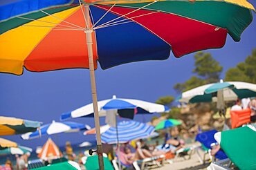 SPAIN Balearic Islands Ibiza Parasols and sunbathers on the beach at Portinatx.   Leisure Tourism Holidays Sunshine Colour