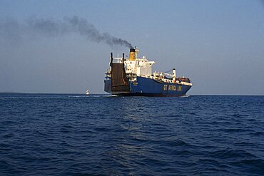 GHANA  Transport Container ship leaving Tema port emitting stream of thick black smoke from central funnel. West Africa   Air pollution  vessel