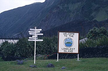 TRISTAN DA CUNHA  Communication Sign with Welcome to the Loneliest Island written on it next to a direction sign post Tristan da Cunha is a group of remote islands in the south Atlantic Ocean. It is a dependency of the British overseas territory of Saint Helena