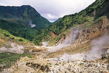 DOMINICA Trois Pitons Nat. Park Valley of Desolation Landscape with steam rising from geysers on rocky valley floor. Windward Islands