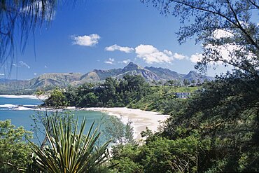 MADAGASCAR  Fort Dauphin Libanona Beach with view across plants and vegetation towards sandy stretch of beach and sea with mountains in the distance