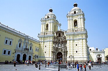 PERU  Lima San Francisco baroque church and monastery. ravel Tourism Holiday Vacation Explore Recreation Leisure Sightseeing Tourist Attraction Tour Destination San Francisco Baroque Lima Peru Peruvian South America Blue Sky Tranquility Tranquil Vivid Vibrant City Capital Tradition Traditional Culture Cultural Building Architecture Architectural Church Churches Religion Religious Pray Prayer Worship Worshipping Worshiping Christianity Holy Divine Christian Theology Faith Sacred Devout Catholic Catholicism Magnificent Impressive Majestic Faade Edifice Bell Tower Spire Steeple Landmark Ethnic Dominant Dominating Prominent People Visitors Converge Converging Convergent UNESCO World Heritage Site Monastery Monasterio Colonial Courtyard Yellow Calendar American South America