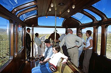 PERU  Transport Passengers relaxing in observation carriage of Puno to Cusco Perurail train journey. Cuzco Travel Tourism Holiday Vacation Explore Recreation Leisure Sightseeing Tourist Attraction Tour Destination Puno Cusco Cuzco Peru Peruvian South Southern America Latin Transport Transportation Travelling Relax Relaxation Relaxing Relaxed Comfort Comfortable Style Stylish Enjoyment Trippers Culture Cultural Traditional Tradition Fun Day Trip Daytrip Pleasure Carriage Coach Train Vehicle Commute Commuters Commuting Moving People Visitors Passengers Tourists Sightseers Holidaymakers Men Women Ladies Window Andes Andean Railway Railways First Class Luxury Luxurious Several Many Pullman Romantic Journey Blue Sky Roof Ceiling Open Rear Observation Vistadome Talking Chatting Track Lines Viewing Calendar American South America Traveling