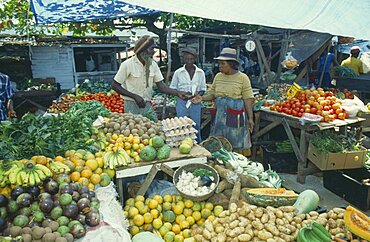 WEST INDIES Jamaica Montego Bay Two women buying fruit from vendor in market