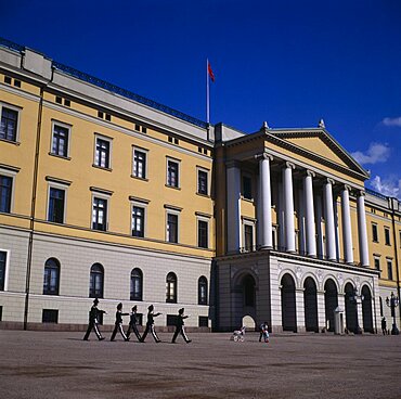 Royal Palace frontage with five guardsmen marching and sentry box, Oslo, Akershus, Norway