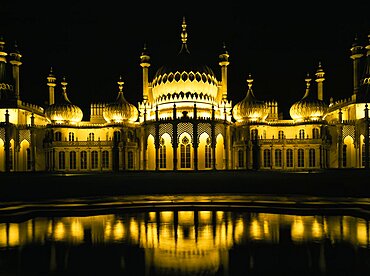 The Royal Pavilion illuminated at night with reflection in pond, Brighton, East Sussex, England, United Kingdom