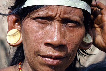 Portrait of a Waorani Indian woman wearing balsa ear plugs, Amazon, Ecuador