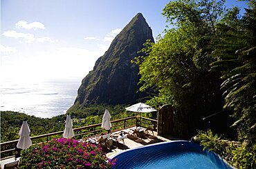 Val des Pitons Tourists sunbathing on the sun deck beside the pool at Ladera Spa Resort Hotel overlooking Petit Piton volcanic plug and Jalousie beach, Soufriere, St Lucia