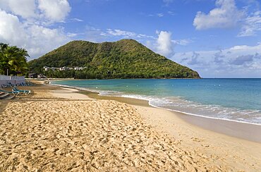 Reduit Beach in Rodney Bay during the early morning with tourists walking by the waterline, Gros Islet, St Lucia