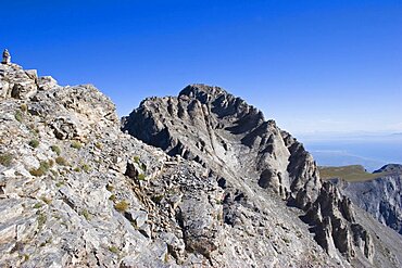 View of highest peak of Mount Olympus called Mytikas, Eroded rocks and scree against blue cloudless sky, Pieria, Macedonia, Greece