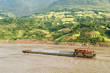 Barge on the Yangtze River near Wushan passing rich farmland, Wushan, Chongqing, China