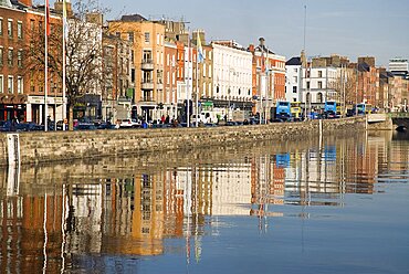 Quayside buildings reflected in the River Liffey near Capel Street Bridge, Ireland, Eire