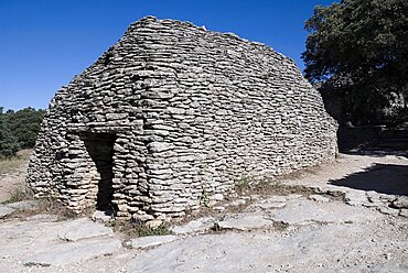 Abandoned primitive village near Gordes comprising of small huts made from overlapping stone, each with a specific function, Le Village des Bories, Provence, France Europe