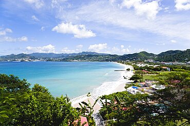 Aquamarine sea and the two mile stretch of the white sand of Grand Anse Beach with St. Georges in the distance, Grenada, West Indies, Caribbean, Central America