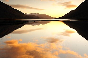 Sunset coloured clouds reflected in Loch Etive, United Kingdom