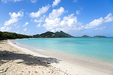 Waves breaking on Paradise Beach at LEsterre Bay with the turqoise sea and Point Cistern and The Sister Rocks beyond, Caribbean