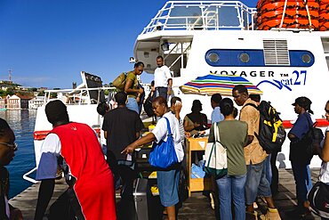 The Osprey Shuttle catamaran inter island service in the Carenage with passengers boarding in the morning for Carriacou and Petit Martinique, Caribbean