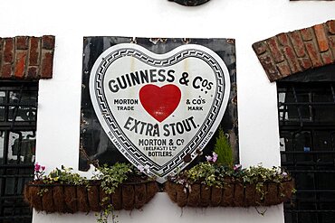 Cathedral Quarter Commerical Court Old metal Red Heart Belfast Bottled Guinness sign decorating the exterior of the Duke of York Public House, Northern Ireland