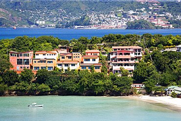 BBC Beach in Morne Rouge Bay lined with holiday apartment villas and the capital of St Georges in the distance, Caribbean