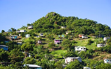 Houses built on stilts lining a hillside, Caribbean