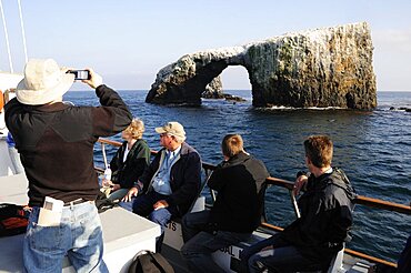 Tour boat passing Arch Rock East Anacapa Channel Isles, Santa Barbara, United States of America