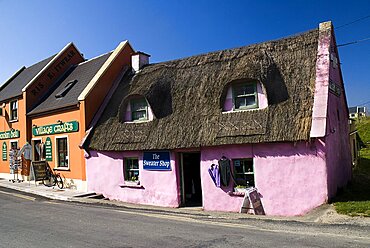 Ireland, Couty, Clare, Doolin, Colourful craft shops in village - one with thatched roof