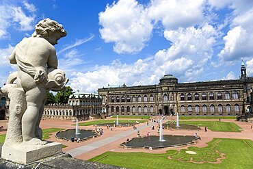 GERMANY, Saxony, Dresden, The central Courtyard and Picture Gallery of the restored Baroque Zwinger Palace gardens busy with tourists seen from the statue lined Rampart originally built between 1710 and 1732 after a design by Matth?us Daniel P?ppelmann in collaboration with sculptor Balthasar Permoser