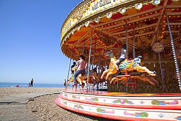 United Kingdom, England, East Sussex, Brighton, Carousel on the pebble beach promenade