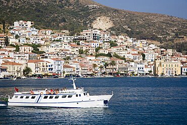 Greece, Northern Aegean, Samos, Vathy, ferry between Samos and Kusadasi in Turkey as it leaves Vathy Town houses spread across hillside behind