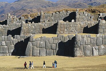 PERU Cusco Department Sacsayhuam?n People walking infront of the Inca walls.