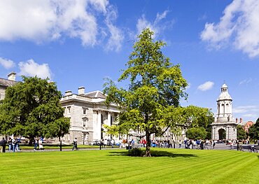 Ireland, County Dublin, Dublin City, Trinity College university with people walking through Parliament Square towards the Campanile.