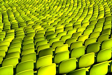 Germany, Bavaria, Munich, Olympic Stadium. Curved section of bright green seating in the stadium.