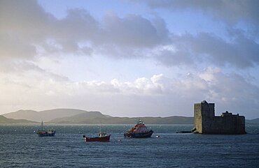 Castle Bay Kisimul Castle overlooking sea and fishing boats, Isle of Barra, Outer Hebrides, Scotland