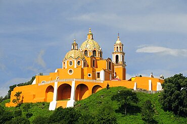 Church of Neustra Senor de los Remedios or Our Lady of Remedios on wooded hillside above the pyramid ruins with brightly painted exterior in neoclassical style, Cholula, Puebla, Mexico