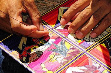 Cropped view of artist making reed painting, Cholula, Puebla, Mexico