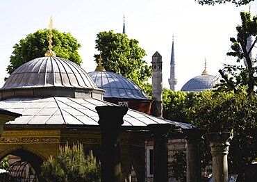 Sultanahmet Haghia Sophia Ablutions Fountain with dome and minarets of the Blue Mosque beyond, Istanbul, Turkey