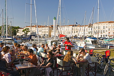 Open-air restaurant seating next to the ancient harbour at La Rochelle, Charente-Maritime, France, Europe