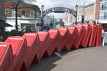 Red telephone box sculpture Out of Order by David Mach. Kingston Upon Thames, Surrey, England, United Kingdom, Europe