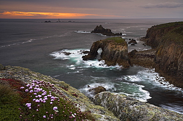 Waves crash over the rocky headland at Land's End, Cornwall, England, United Kingdom, Europe