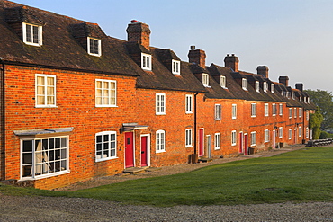 Summer morning sunshine glows on the terraced cottages at Bucklers Hard, Hampshire, England, United Kingdom, Europe