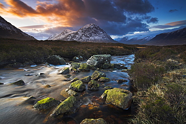 A boulder strewn stream meanders towards Buachaille Etive Mor, Highland, Scotland, United Kingdom, Europe