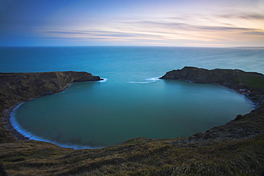 Twilight on the clifftops overlooking the circular Lulworth Cove, Jurassic Coast, UNESCO World Heritage Site, Dorset, England, United Kingdom, Europe