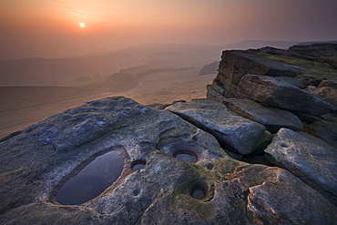 A misty sunset over Stanage Edge, Peak District National Park, Derbyshire, England, United Kingdom, Europe