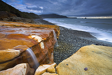 Water-stained sandstone on Seven Mile Beach, South Island, New Zealand, Pacific